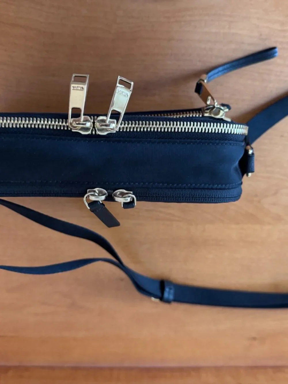 Authentic TUMI Voyageur Langley Crossbody in black with gold-tone hardware
